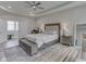 Bright main bedroom boasts tray ceiling, wood floors, and natural light creating a serene and inviting atmosphere at 847 E Jefferson St, Franklin, IN 46131