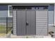 A modern storage shed sits adjacent to the house and has gray wood panelling and black trim and double doors at 847 E Jefferson St, Franklin, IN 46131