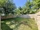 Grassy backyard enclosed by a wooden fence, offering a private and spacious outdoor area at 8829 Tracy Dr, Clayton, IN 46118