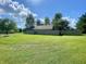 Spacious backyard with lush green lawn and privacy fence at 8829 Tracy Dr, Clayton, IN 46118