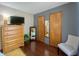 Bedroom with hardwood floors, neutral paint, and closet storage at 8829 Tracy Dr, Clayton, IN 46118
