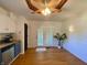 Dining area with hardwood floors, ceiling fan, and access to the outdoor patio at 8829 Tracy Dr, Clayton, IN 46118