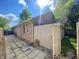Exterior view of house with brick and siding, a paved walkway, and an enclosed patio area at 8829 Tracy Dr, Clayton, IN 46118
