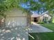Exterior of home with attached garage, brick accents, and landscaped front yard at 8829 Tracy Dr, Clayton, IN 46118