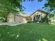 Charming single-story home with brick facade, mature trees, and a well-manicured lawn at 8829 Tracy Dr, Clayton, IN 46118
