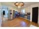 Kitchen boasts stainless steel appliances, two-toned cabinets, and hardwood floors at 8829 Tracy Dr, Clayton, IN 46118