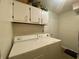 Laundry room featuring washer and dryer with upper cabinets at 8829 Tracy Dr, Clayton, IN 46118