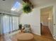 Bright living room features hardwood floors, skylight, cozy seating, and patio door at 8829 Tracy Dr, Clayton, IN 46118