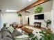 Cozy living room features hardwood floors, skylight, wood beam, and plant accents at 8829 Tracy Dr, Clayton, IN 46118