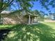 Back patio features chair swing and brick exterior at 8829 Tracy Dr, Clayton, IN 46118
