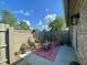 Enclosed brick patio with wicker furniture, a coffee table, a patterned outdoor rug, and green plants at 8829 Tracy Dr, Clayton, IN 46118