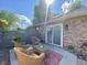 Cozy brick patio featuring wicker furniture, a red patterned outdoor rug, and a privacy fence at 8829 Tracy Dr, Clayton, IN 46118