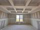 Bedroom with a modern tray ceiling, bright window, and walls prepped with drywall awaiting customization at 9417 Crimson Cir, Lapel, IN 46051