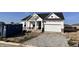 New construction home featuring a two-car garage and a partially graveled driveway at 9417 Crimson Cir, Lapel, IN 46051