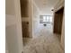 Under construction hallway showing an open layout, visible drywall, and natural light streaming in from the windows at 9417 Crimson Cir, Lapel, IN 46051