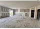 Spacious living room with drywall installed, featuring large windows and sliding glass doors to the outside at 9417 Crimson Cir, Lapel, IN 46051