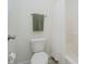 Bright bathroom featuring a toilet and shower with a white shower curtain and olive-green towel at 9689 Exchange St, Fishers, IN 46038