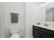 Bathroom with a toilet, vanity with dark cabinets, and a large mirror at 9689 Exchange St, Fishers, IN 46038