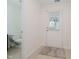 Bright entryway with a white door and a view to a half bathroom with tile flooring at 9689 Exchange St, Fishers, IN 46038