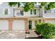 Charming townhome featuring an attached garage, green door, and well-maintained landscaping at 9689 Exchange St, Fishers, IN 46038
