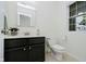 A pristine half-bathroom featuring a modern vanity, toilet, and a large mirror at 9689 Exchange St, Fishers, IN 46038