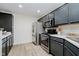 Modern kitchen featuring gray cabinetry, stainless steel appliances, and ample counter space at 9689 Exchange St, Fishers, IN 46038