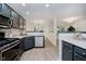 Modern kitchen featuring gray cabinetry, stainless steel appliances, and bright, natural light at 9689 Exchange St, Fishers, IN 46038