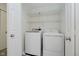 Laundry room with a washer, dryer, and wire shelving for storage at 9689 Exchange St, Fishers, IN 46038