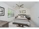 Main bedroom featuring a neutral palette, large window, and ceiling fan at 9689 Exchange St, Fishers, IN 46038