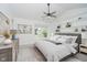 Spacious main bedroom with vaulted ceilings, carpet floors, a ceiling fan, and built-in shelving at 9689 Exchange St, Fishers, IN 46038