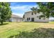 Large, well-maintained backyard with green grass, mature trees, and a relaxing swing at 10658 Pavilion Dr, Indianapolis, IN 46259