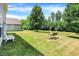 Spacious backyard with lush green grass and mature trees provides an area for outdoor enjoyment at 10658 Pavilion Dr, Indianapolis, IN 46259