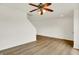 Spacious room with wood floors, ceiling fan, and neutral walls at 10658 Pavilion Dr, Indianapolis, IN 46259