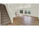 Open-concept room with wood floors and staircase leading to the upper level at 10658 Pavilion Dr, Indianapolis, IN 46259