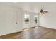 Bright living room with wood floors, a ceiling fan and natural light from two windows at 10658 Pavilion Dr, Indianapolis, IN 46259