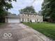 Traditional two-story home with stone exterior, attached garage, and green lawn at 10720 Lakeview Dr, Carmel, IN 46033