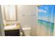 Bathroom showcasing a vanity, toilet, and a shower with a beach-themed curtain at 11445 Congaree Way, Indianapolis, IN 46235