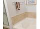Bathroom featuring a bathtub with stylish tile surround and a sleek towel rack at 11445 Congaree Way, Indianapolis, IN 46235