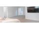 Bright bedroom featuring light-colored walls, carpeted floors, and a wall-mounted television at 11445 Congaree Way, Indianapolis, IN 46235