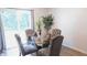 This dining area is well-lit with a sliding glass door and has seating for four on upholstered chairs at 11445 Congaree Way, Indianapolis, IN 46235