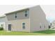 Beige two-story home with sliding glass door and green lawn at 11445 Congaree Way, Indianapolis, IN 46235