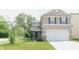 Charming two-story home featuring tan siding, a two-car garage, and a well-maintained front lawn at 11445 Congaree Way, Indianapolis, IN 46235