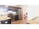 Modern kitchen with stainless steel appliances, dark cabinets, and ample counter space, perfect for cooking at 11445 Congaree Way, Indianapolis, IN 46235