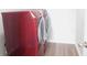 View of a laundry room featuring a red Samsung washer and dryer set at 11445 Congaree Way, Indianapolis, IN 46235