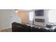 Modern living room featuring a black leather sofa, sleek fireplace, and a mounted TV for entertainment at 11445 Congaree Way, Indianapolis, IN 46235