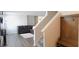 Open living space with wood floors, stairs, and a comfortable sofa, creating an inviting atmosphere at 11445 Congaree Way, Indianapolis, IN 46235