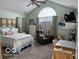 Bedroom boasts vaulted ceilings and a large window for natural light at 11503 Winding Wood Dr, Indianapolis, IN 46235