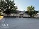 Inviting building exterior surrounded by mature trees, a well-manicured landscape and parking at 11503 Winding Wood Dr, Indianapolis, IN 46235