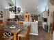 Well-lit kitchen with white cabinets, stainless steel appliances, and adjacent dining area at 11503 Winding Wood Dr, Indianapolis, IN 46235