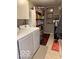 Functional laundry room with modern washer and dryer with overhead cabinets at 11503 Winding Wood Dr, Indianapolis, IN 46235